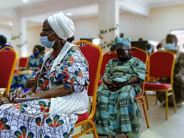 Two senior women seated at a gathering