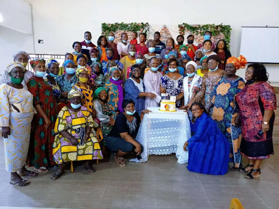Members of Caleb Seniors gathered around a celebration cake